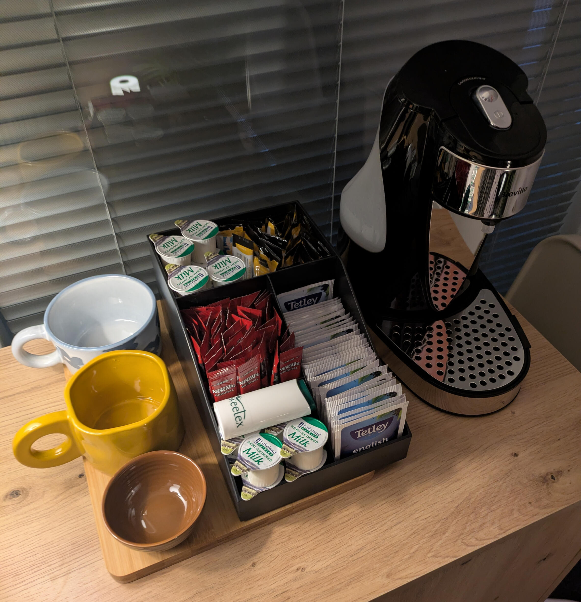Image shows two large chairs sat opposite each other with lots of plants and dimmed lighting and candles. Counselling office based in Burslem ST6.